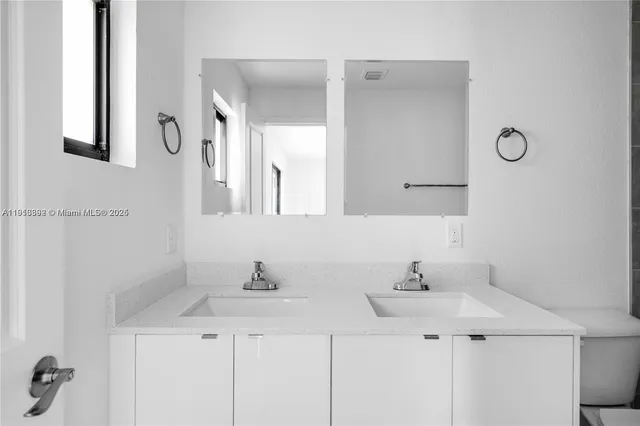 a view of a kitchen with white cabinets