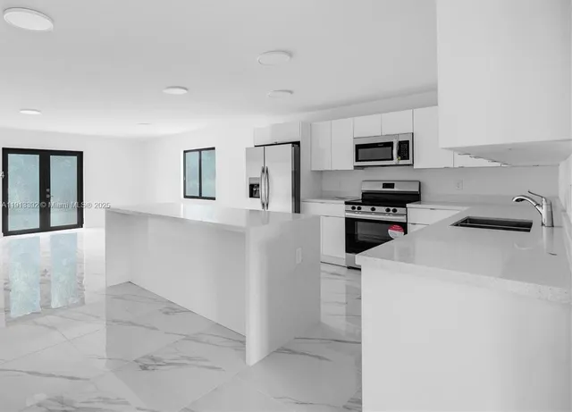 a kitchen that has a sink and a stove