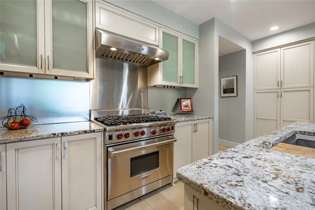 a kitchen with a stove and cabinets