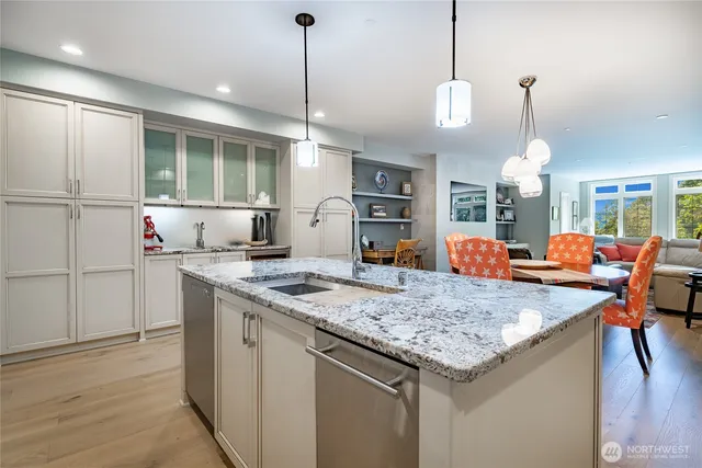 a kitchen with center island table and chairs