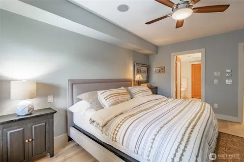 a bedroom with a bed and a chandelier