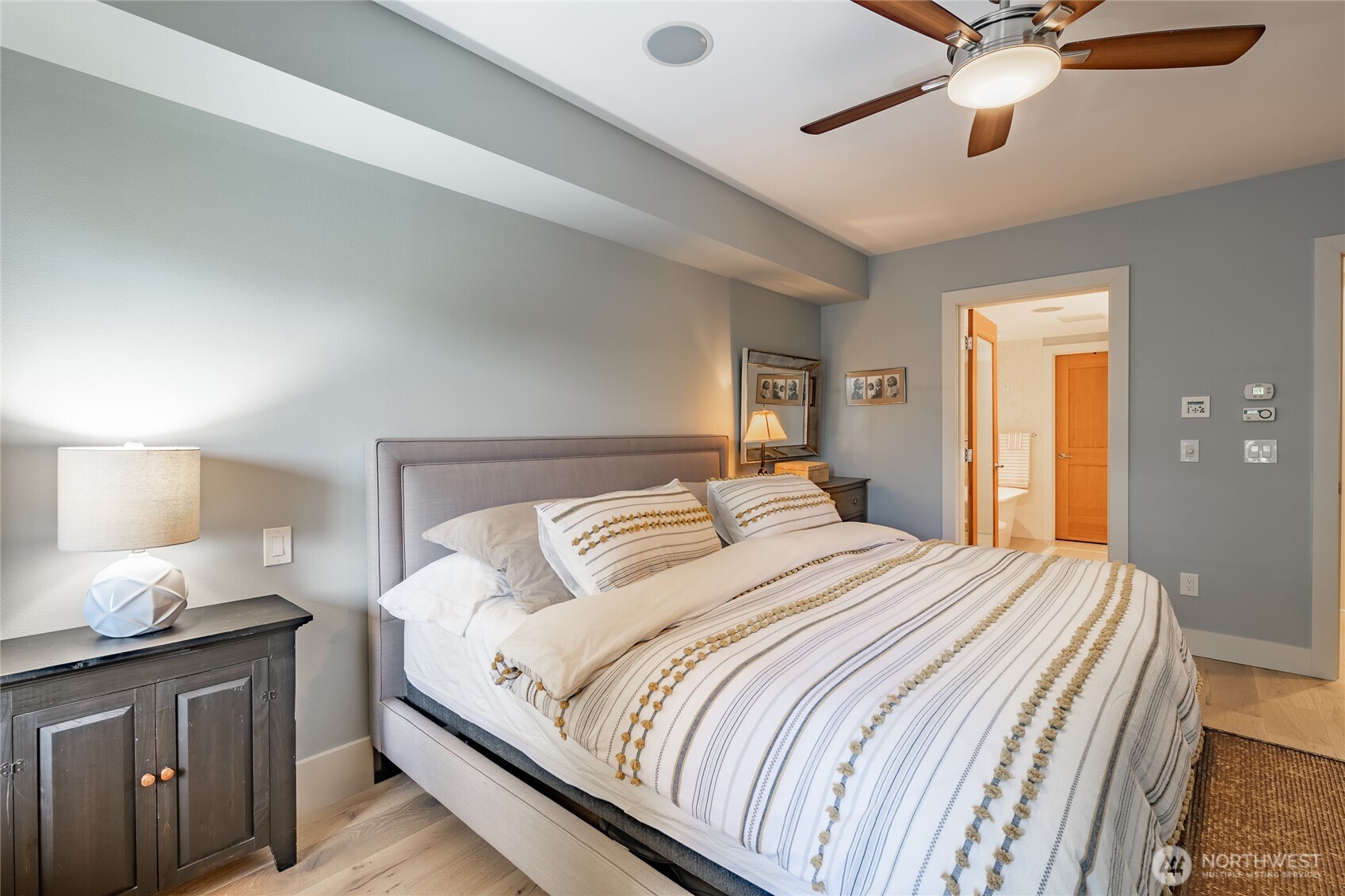 9525 Semiahmoo Parkway, Unit A204 Blaine, WA 98230 - Photo 24 of 37 a bedroom with a bed and a chandelier