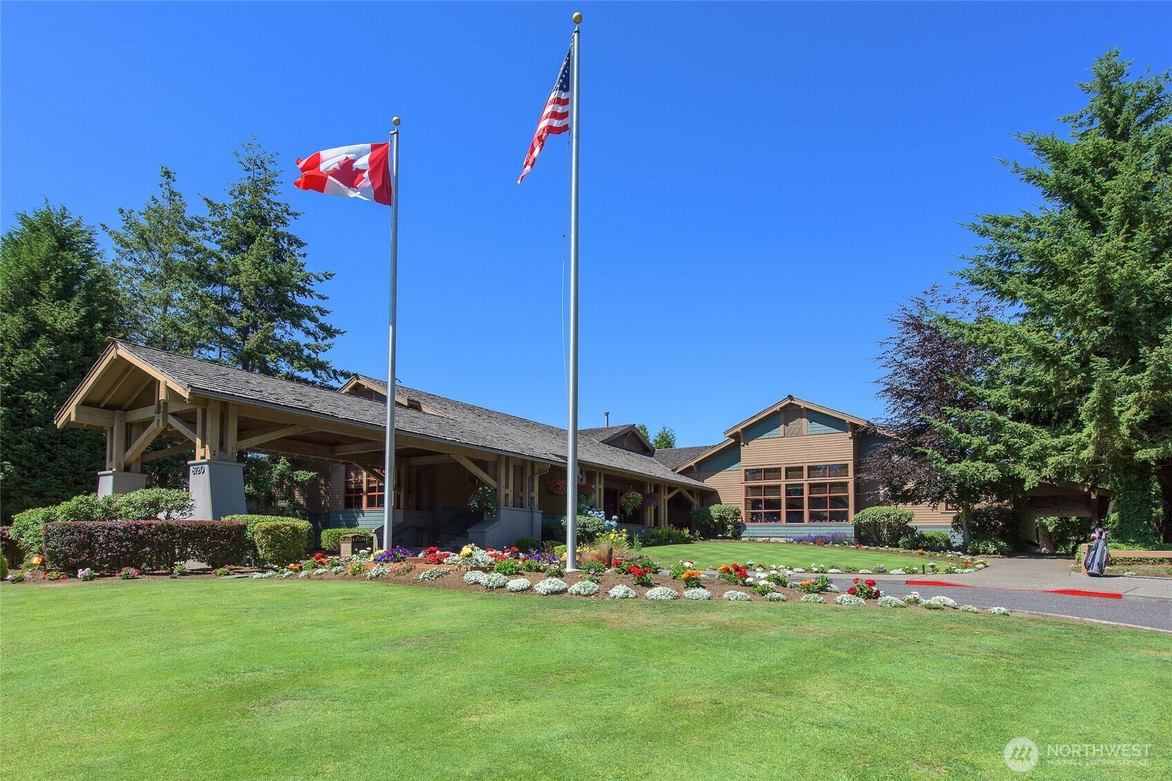 9525 Semiahmoo Parkway, Unit A204 Blaine, WA 98230 - Photo 35 of 37 a front view of a house with a garden