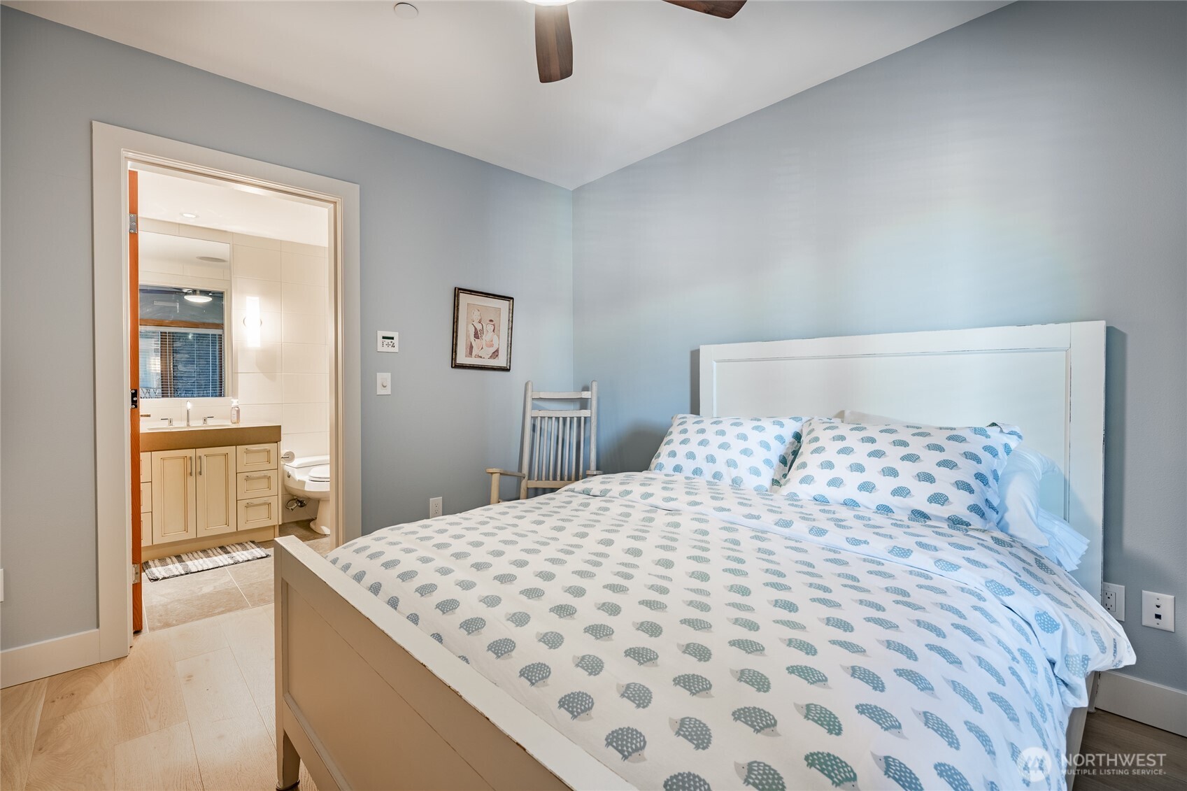 9525 Semiahmoo Parkway, Unit A204 Blaine, WA 98230 - Photo 9 of 37 a bedroom with a large bed and a chandelier