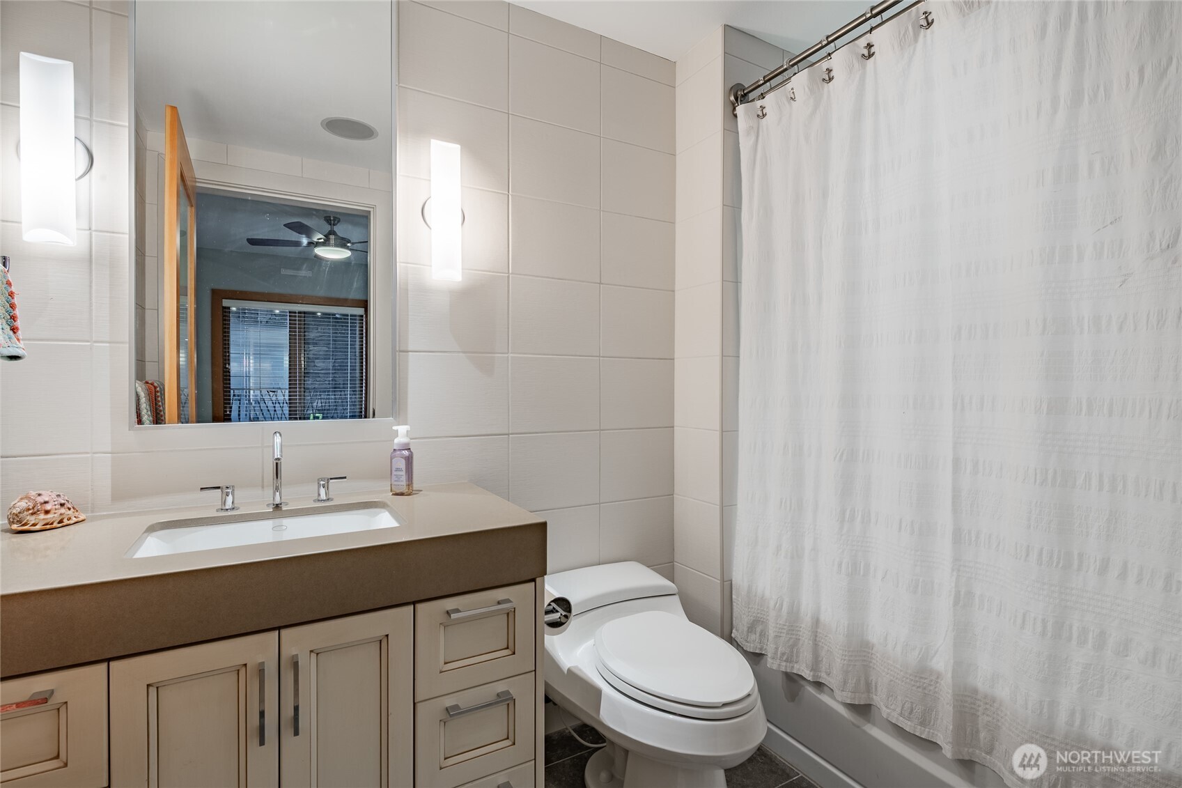 9525 Semiahmoo Parkway, Unit A204 Blaine, WA 98230 - Photo 10 of 37 a bathroom with a sink a toilet and shower