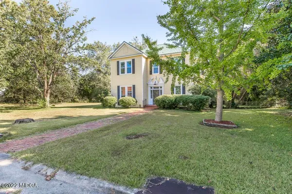 a front view of a house with a yard