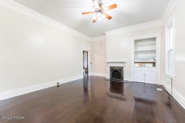 wooden floor in an empty room with a window