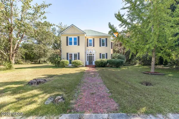 a front view of a house with a yard