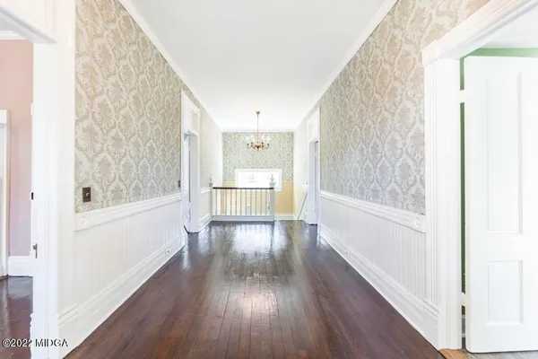 an empty room with wooden floor and fireplace