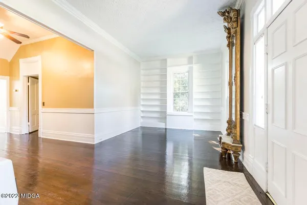 a view of a room with wooden floor and windows