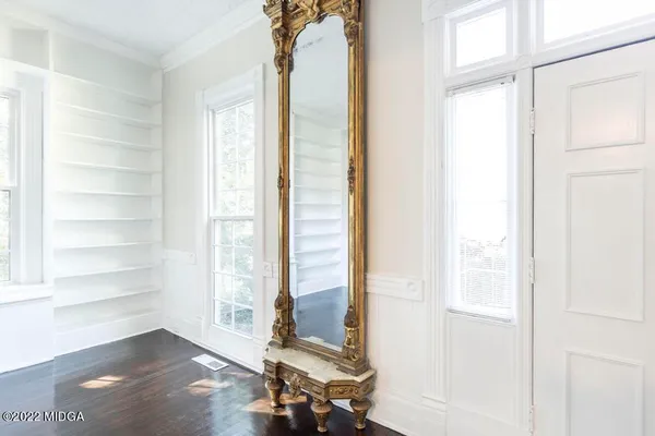 a view of empty room with wooden floor