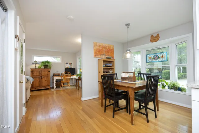 a view of a dining room with furniture window and wooden floor