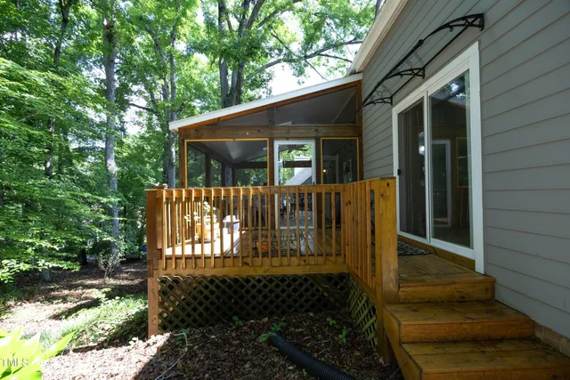 a view of house with backyard and sitting area