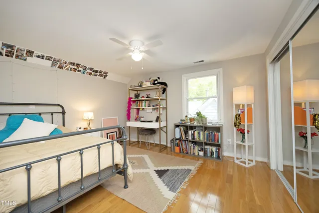 a bedroom with furniture and a wooden floor