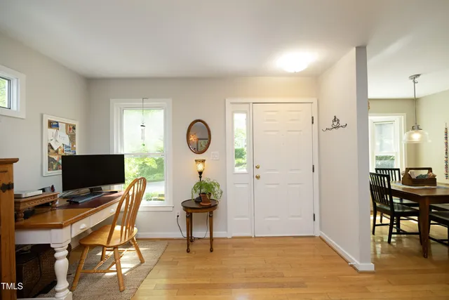 a view of a workspace with furniture and a window