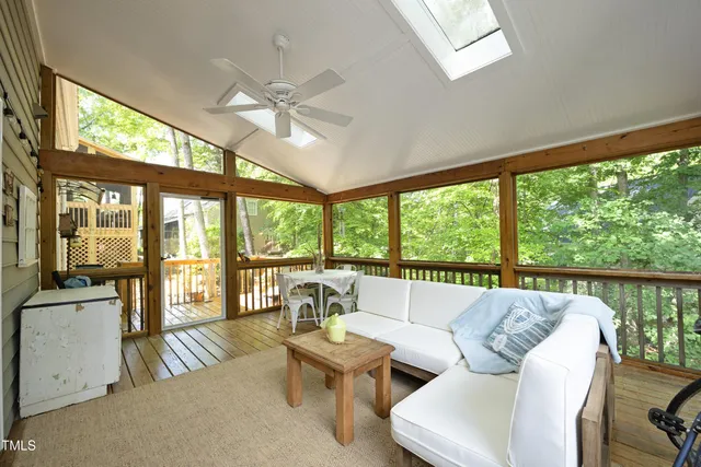 a living room with furniture and a floor to ceiling window
