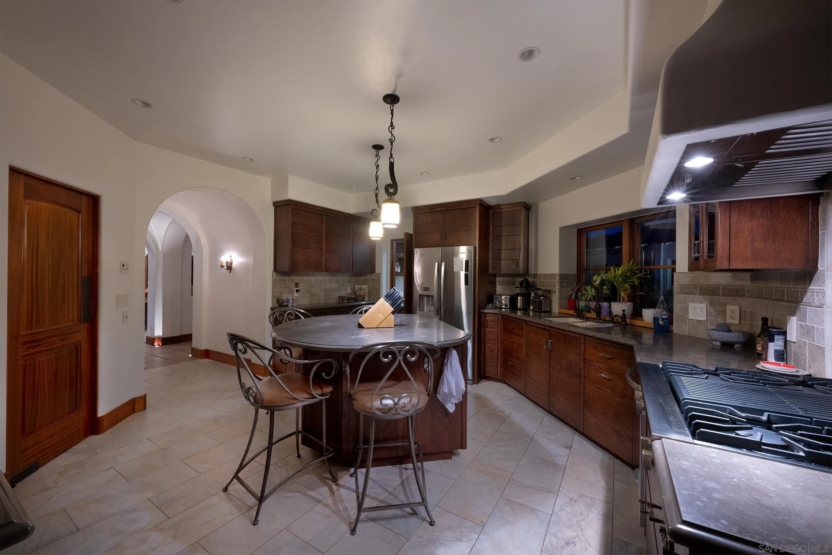 1245 Park Row La Jolla, CA 92037 - Photo 11 of 23 a dining room with a table chairs and kitchen view