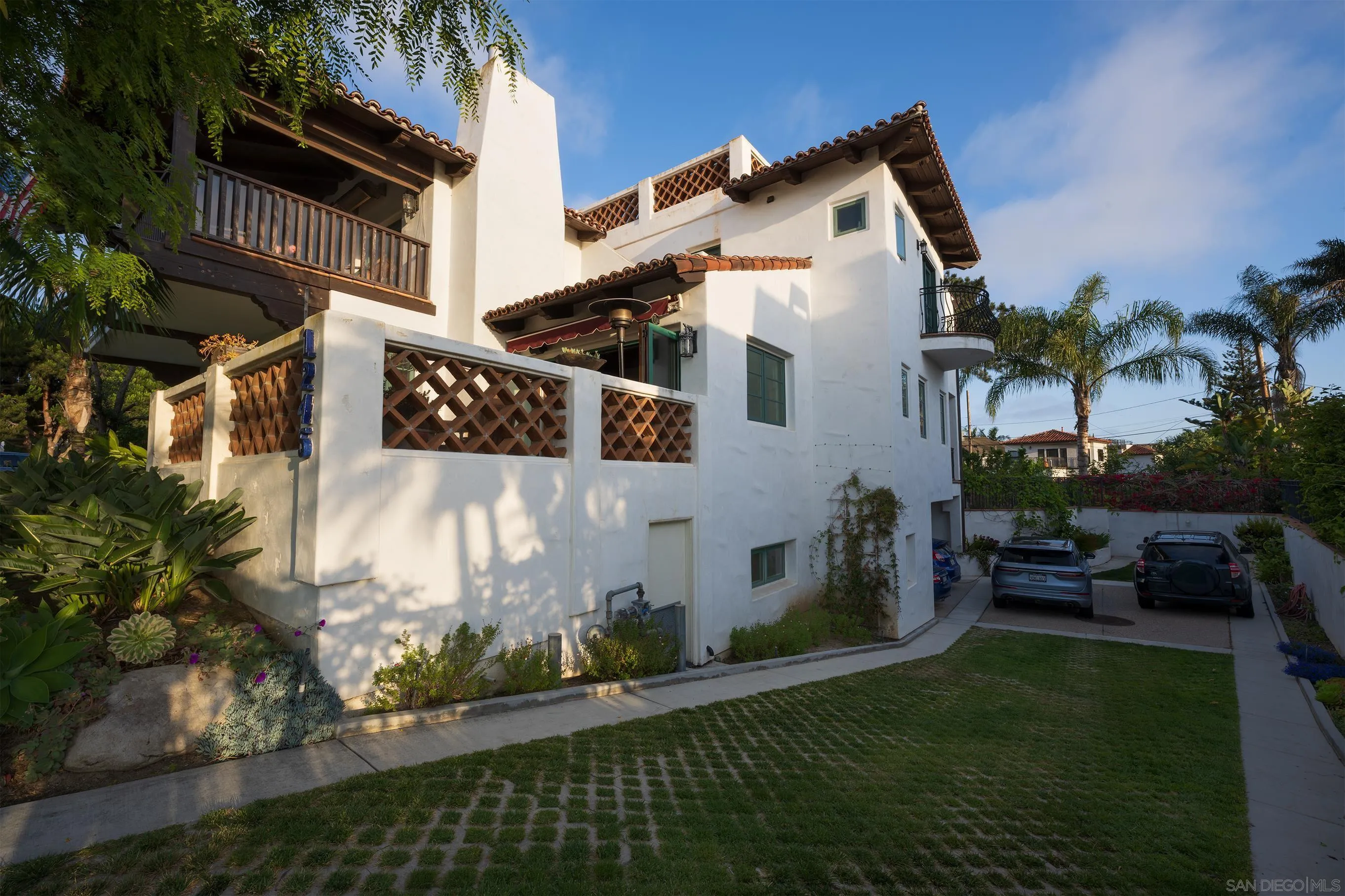 1245 Park Row La Jolla, CA 92037 - Photo 4 of 23 a front view of a house with a garden and yard