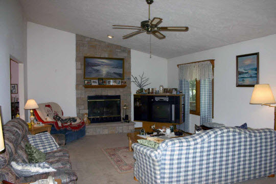 229 Rochester Road Northeast Poplar Grove, IL 61065 - Photo 3 of 6 a living room with furniture a flat screen tv and a fireplace