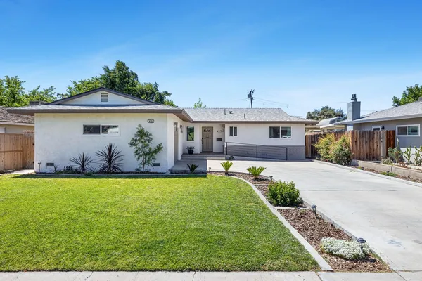 a front view of house with yard and outdoor seating