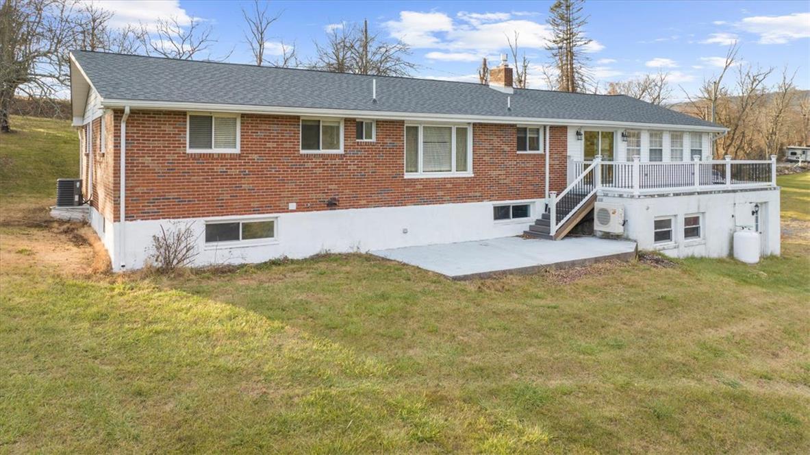 988 Hoch Road Danielsville, PA 18038 - Photo 2 of 29 A well-maintained brick exterior with an elevated deck offers hillside views and outdoor leisure.