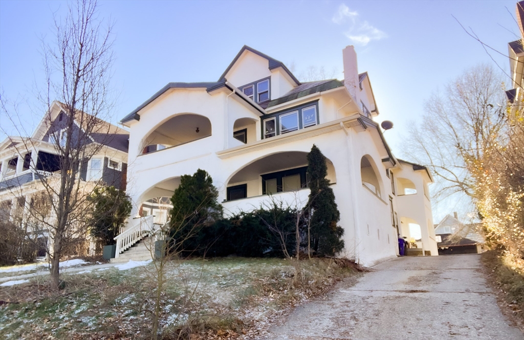 a view of a white house with a large windows