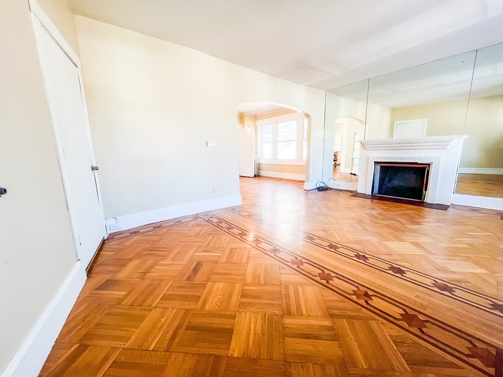 68 Forest Park Avenue Springfield, MA 01108 - Photo 12 of 19 a view of empty room with fireplace and wooden floor