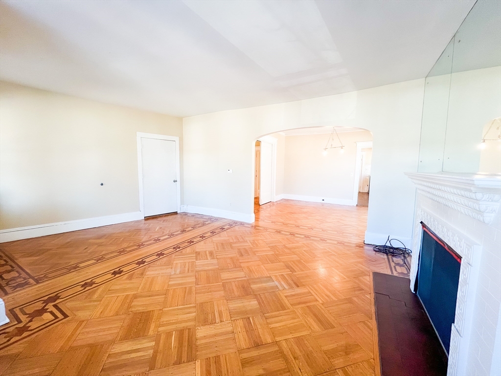 68 Forest Park Avenue Springfield, MA 01108 - Photo 13 of 19 a view of empty room with wooden floor and fan