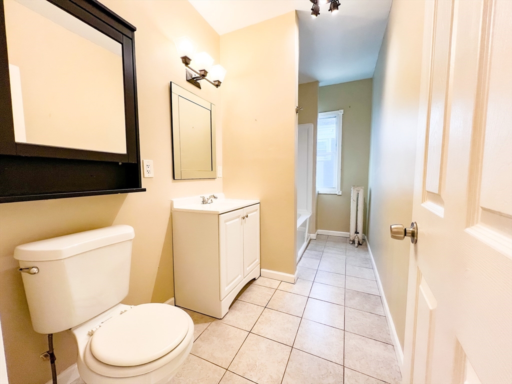 68 Forest Park Avenue Springfield, MA 01108 - Photo 18 of 19 a bathroom with a toilet a sink and a mirror