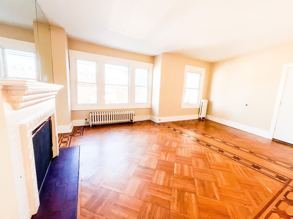68 Forest Park Avenue Springfield, MA 01108 - Photo 19 of 19 a view of empty room with wooden floor and fireplace