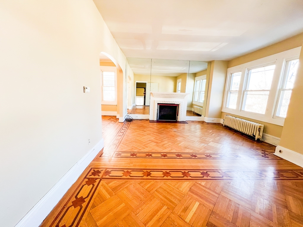 68 Forest Park Avenue Springfield, MA 01108 - Photo 6 of 19 a view of an empty room with wooden floor and a window