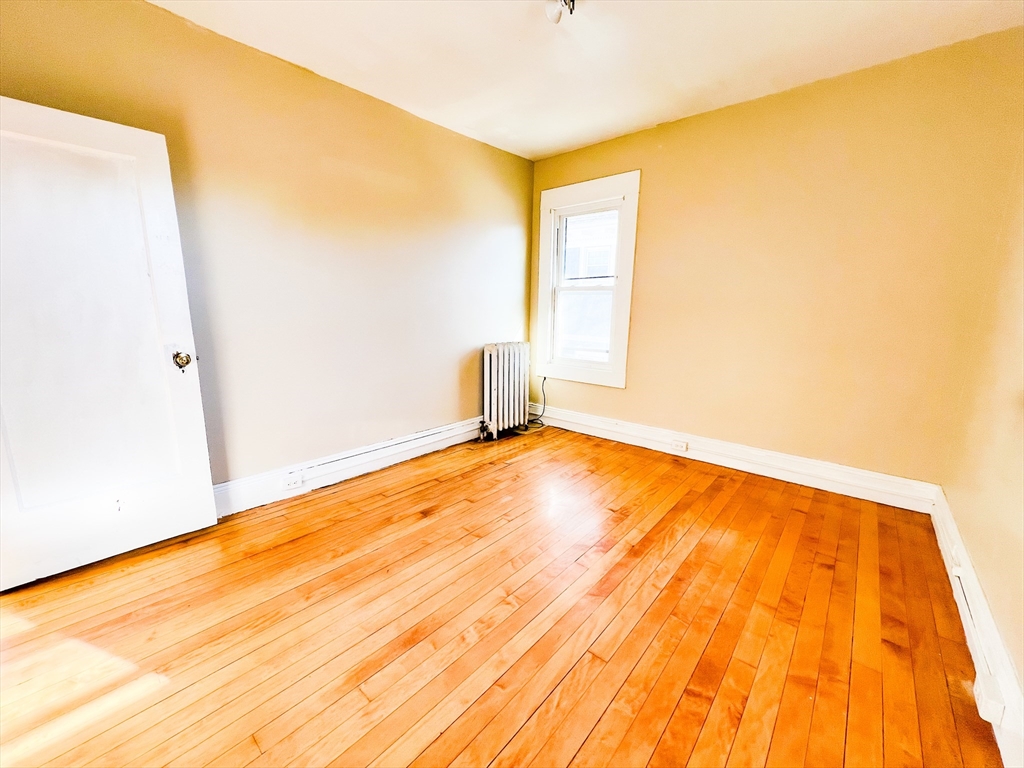 68 Forest Park Avenue Springfield, MA 01108 - Photo 8 of 19 a view of empty room with wooden floor and fan
