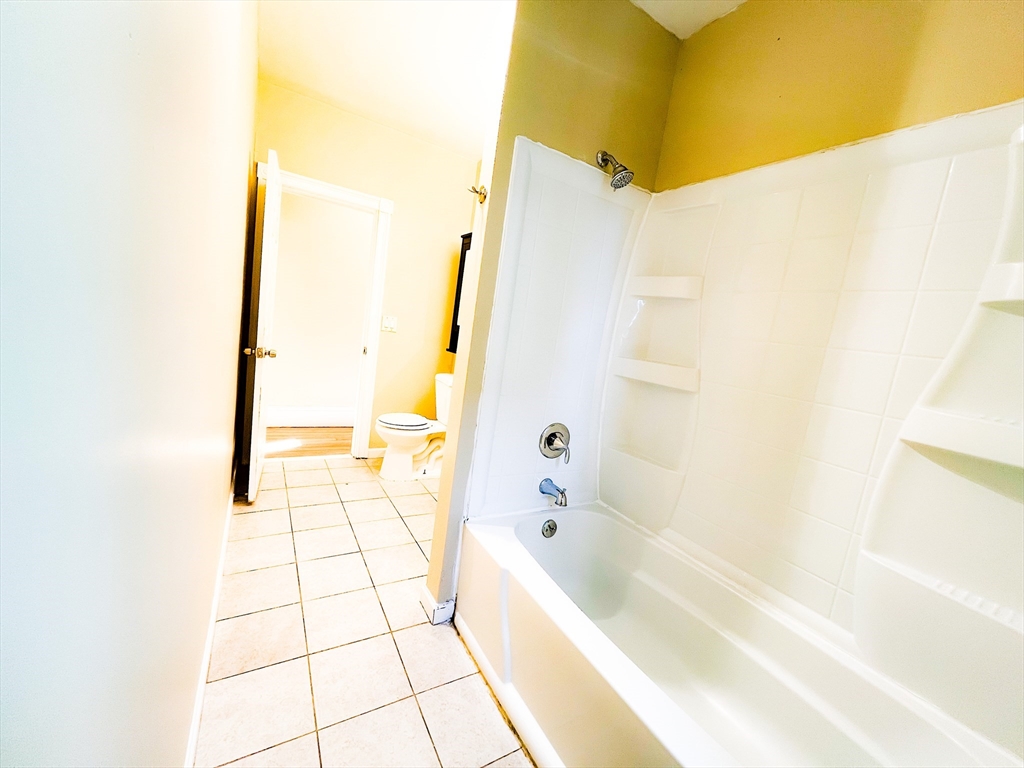 68 Forest Park Avenue Springfield, MA 01108 - Photo 9 of 19 a bathroom with a bathtub and a shower