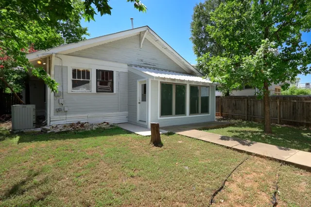 a backyard of a house with table and chairs