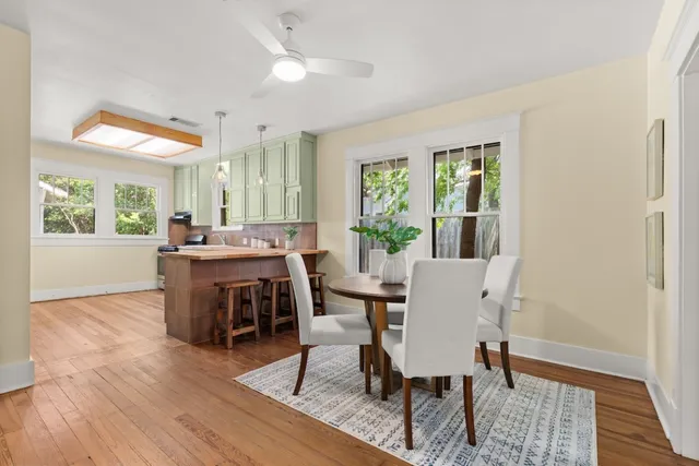 a view of a dining room with furniture window and wooden floor