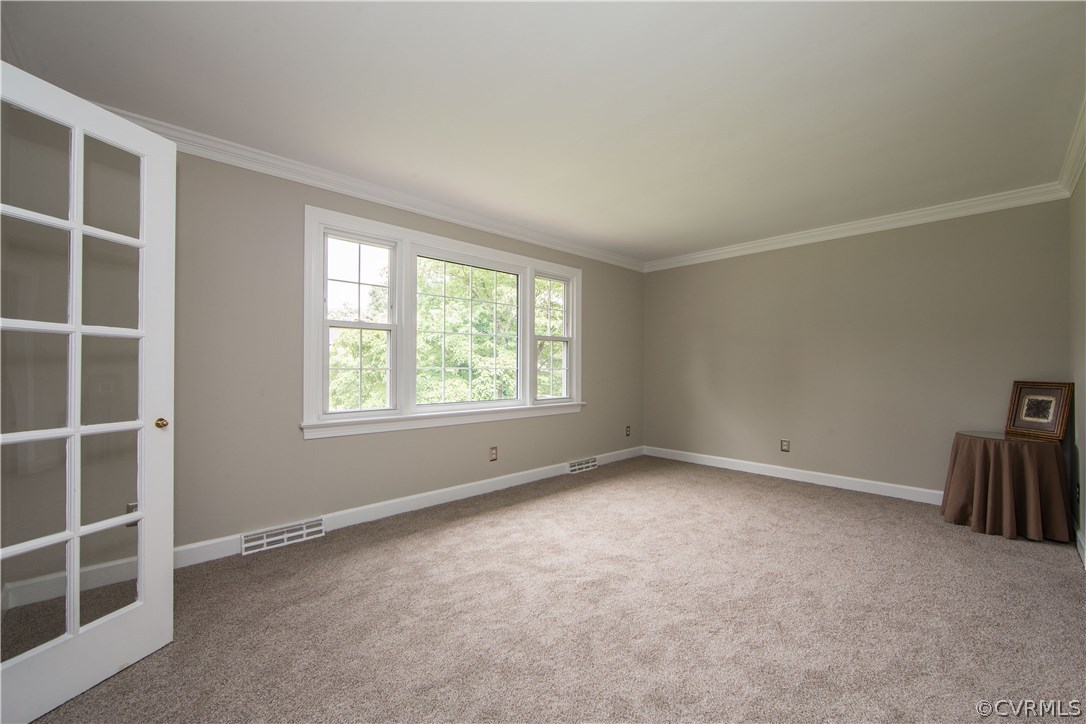 4511 Crossgate Road Chester, VA 23831 - Photo 2 of 21 The living room is spacious, features crown moldin