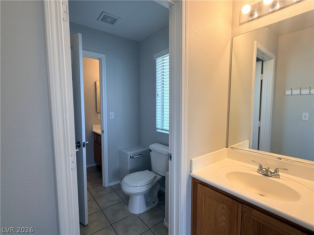 11953 Fairfax Ridge Street Las Vegas, NV 89183 - Photo 11 of 32 A well-appointed bathroom offers practical vanity storage and tiled flooring.