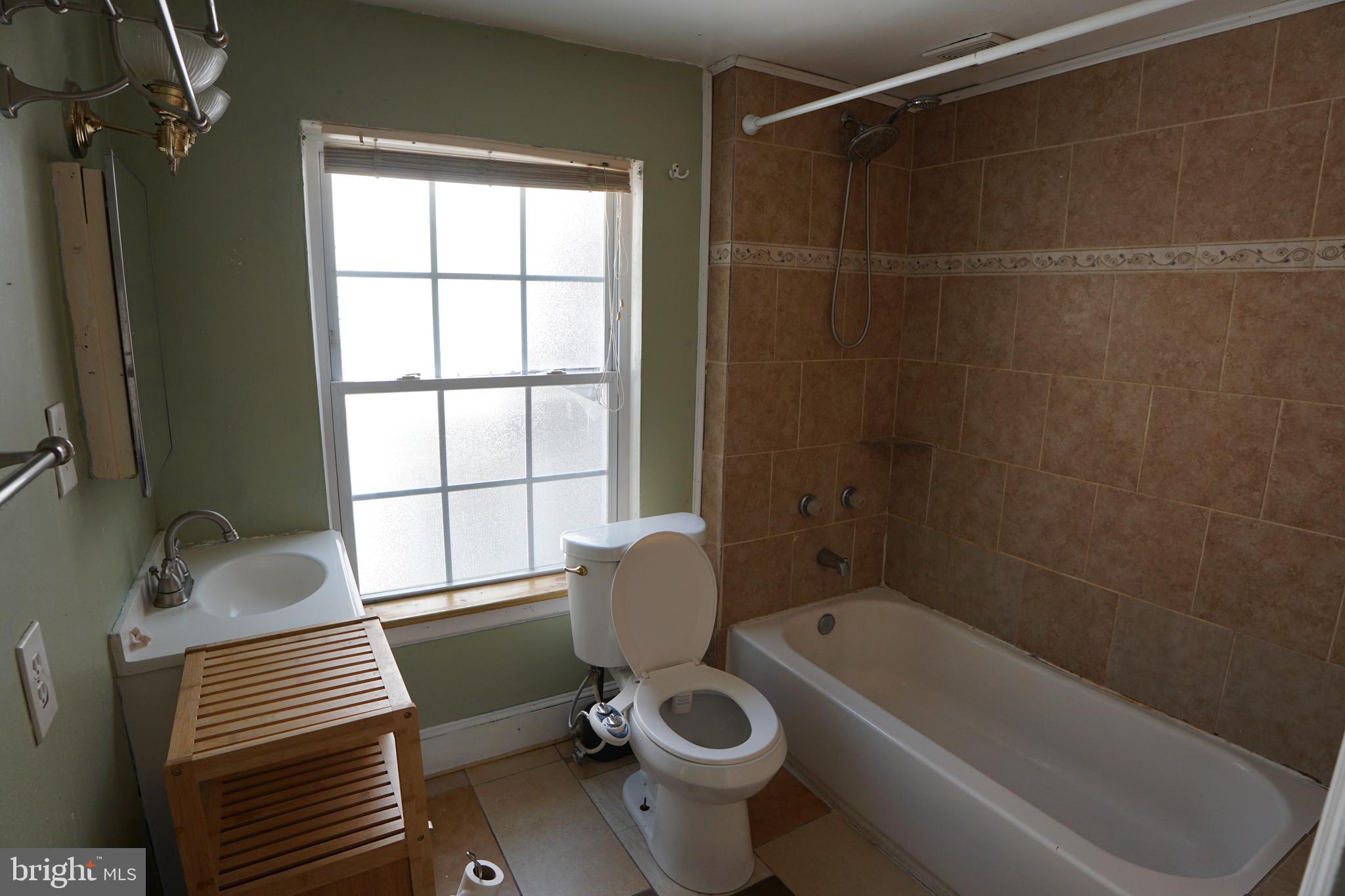 802 Cathedral Street, Unit 4 Baltimore, MD 21201 - Photo 11 of 15 a bathroom with a sink toilet and shower