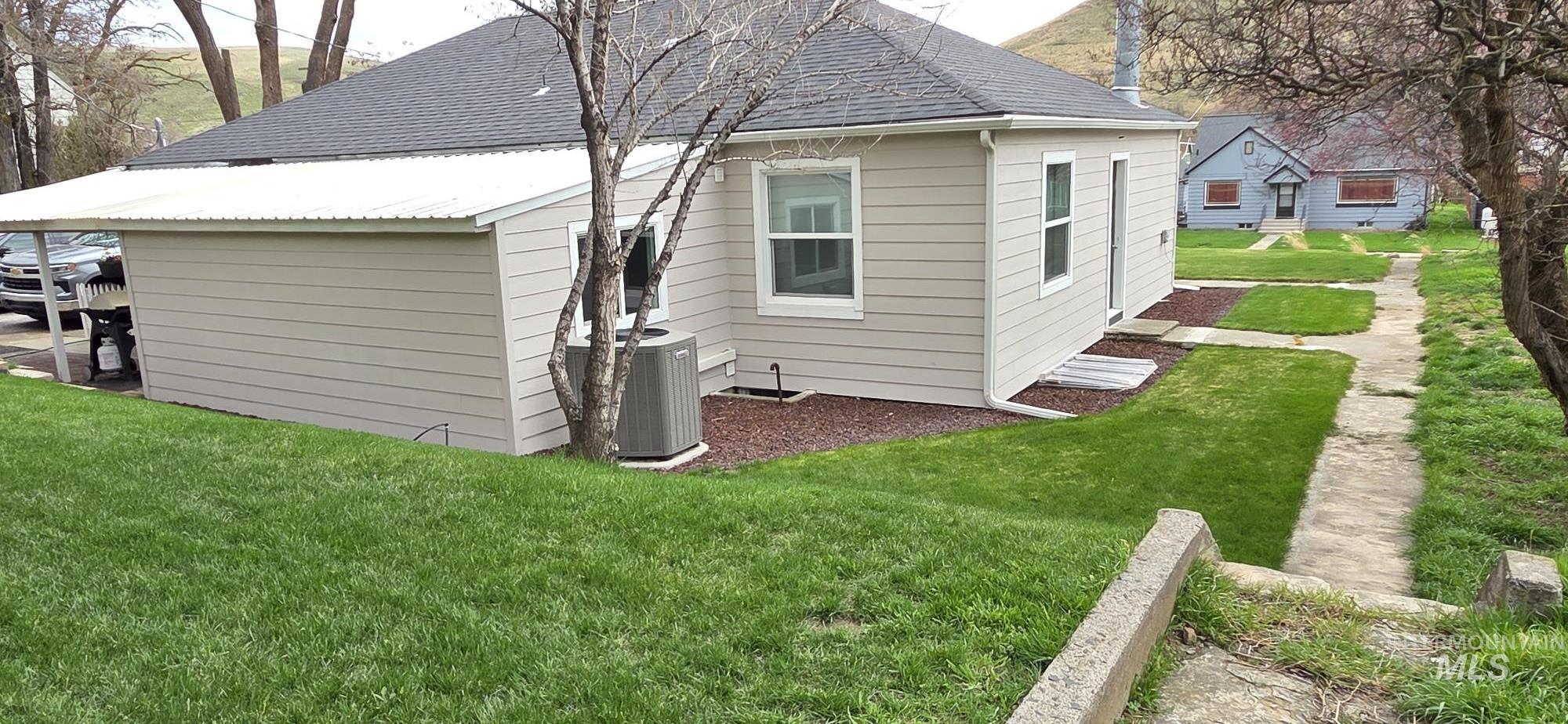 1269 Main Street Pomeroy, WA 99347 - Photo 6 of 38 View of side of home featuring a lawn and roof with shingles