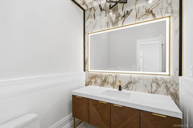 a view of staircase with railing and white walls