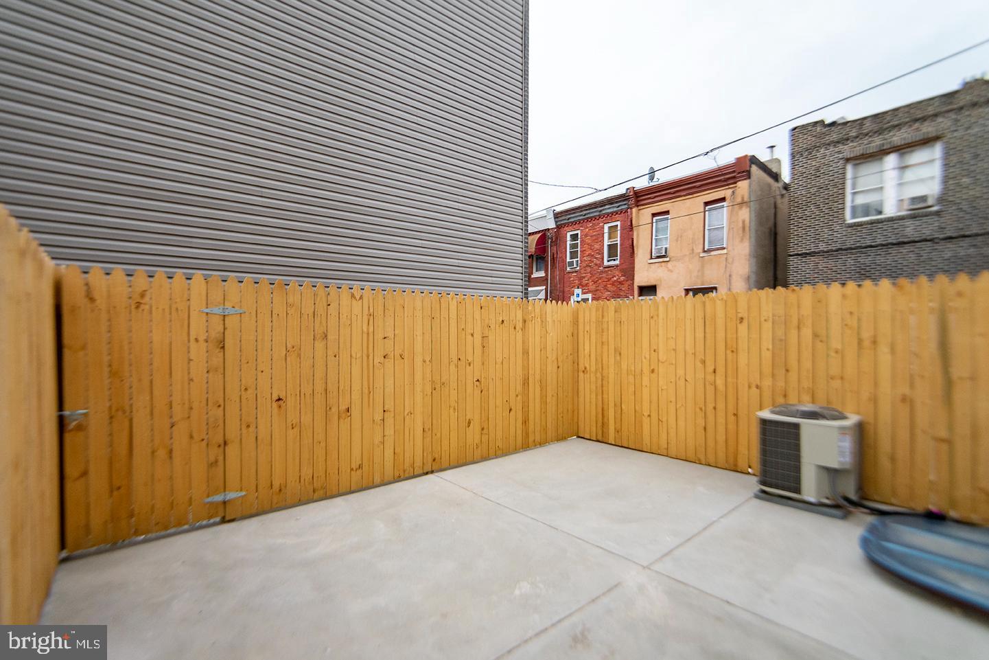1713 South 20th Street, Unit 1 Philadelphia, PA 19145 - Photo 14 of 15 Private outdoor oasis with wooden fencing.