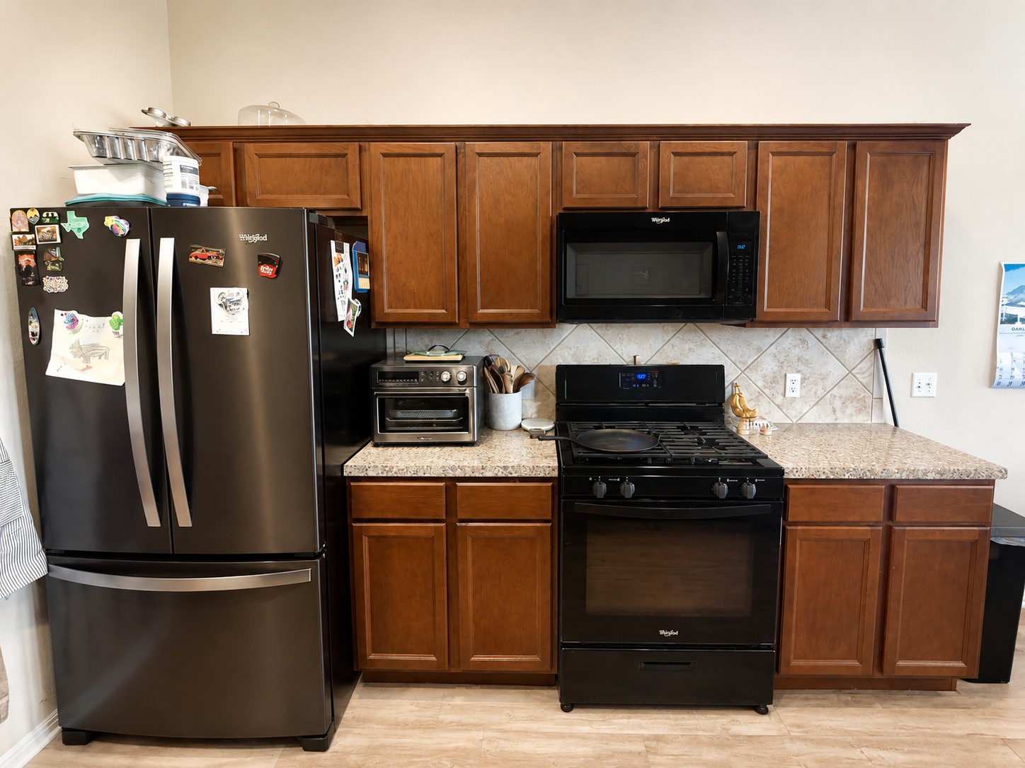 107 Jim Dandy Drive Elgin, TX 78621 - Photo 5 of 15 A well-appointed kitchen features rich wood cabinetry.