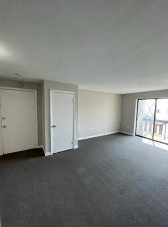 a view of an empty room with a window