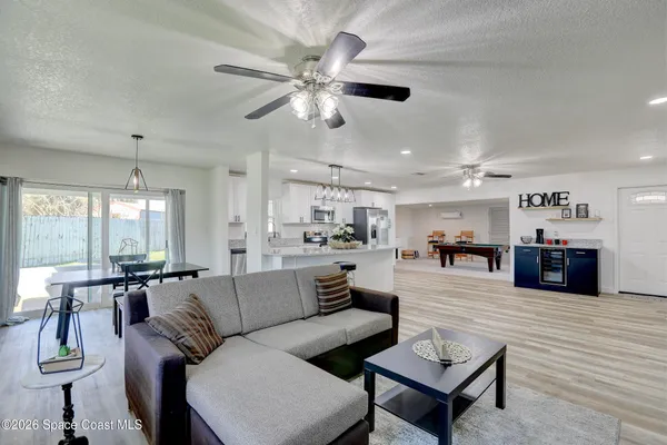 a kitchen with stainless steel appliances a sink a stove and a refrigerator with wooden floor