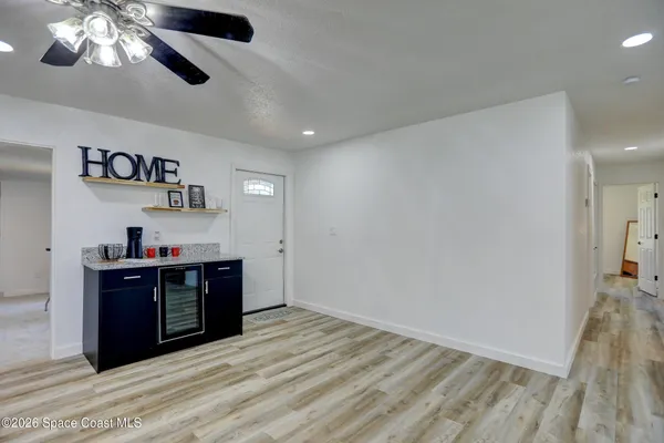 a view of kitchen with refrigerator microwave and cabinets