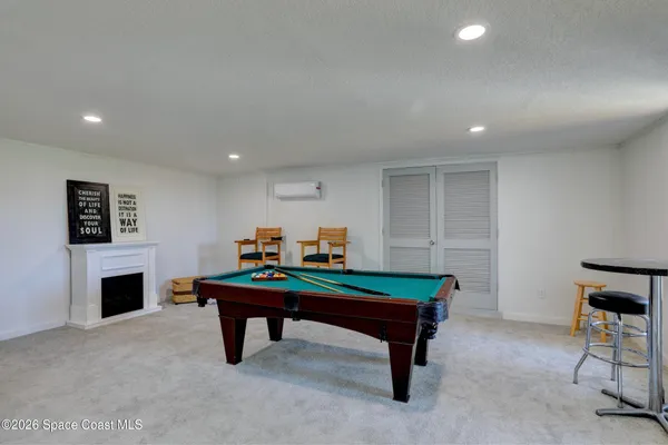 a room with pool table and windows