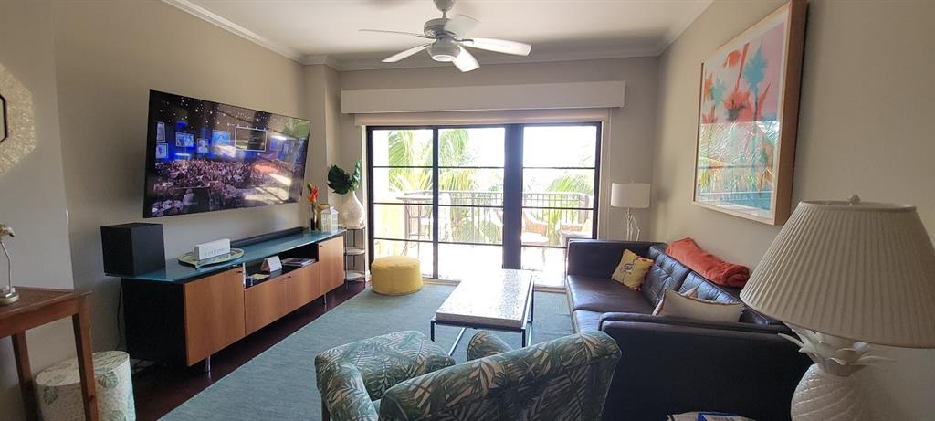2509 North Ocean Boulevard, Unit 576 Fort Lauderdale, FL 33305 - Photo 12 of 22 a living room with furniture and a flat screen tv
