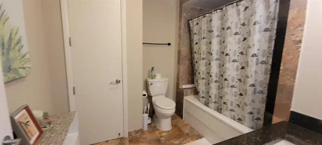 a bathroom with a toilet and shower