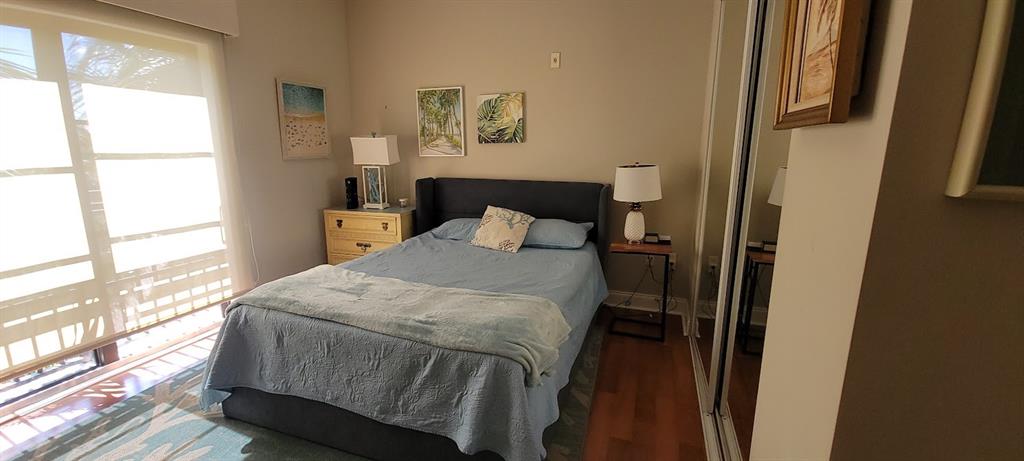 2509 North Ocean Boulevard, Unit 576 Fort Lauderdale, FL 33305 - Photo 20 of 22 a bedroom with a bed and wooden floor