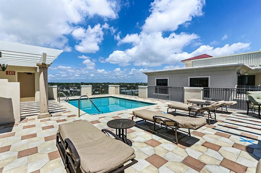 2509 North Ocean Boulevard, Unit 576 Fort Lauderdale, FL 33305 - Photo 3 of 22 a view of a patio with dining table and chairs with wooden floor